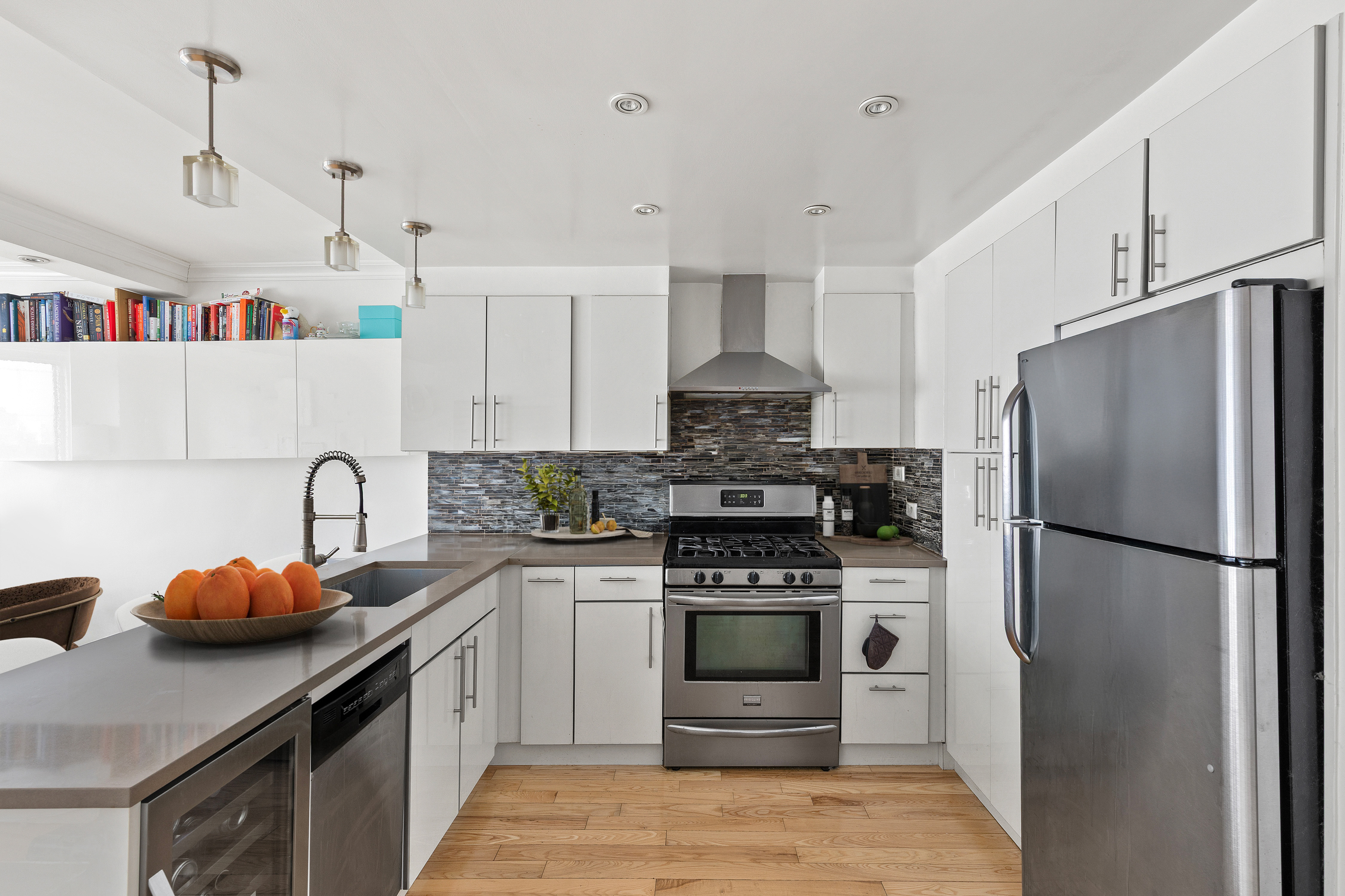 201 East 25th Street, Unit 7F Manhattan, NY 10010 - Photo 3 of 10 a kitchen with stainless steel appliances a refrigerator sink and stove