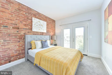 a bedroom with a bed and a windows