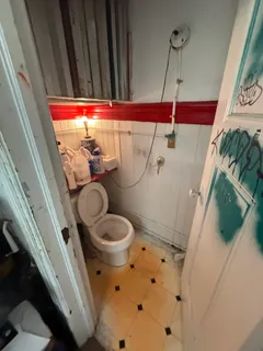 a view of a hallway with wooden floor and closet
