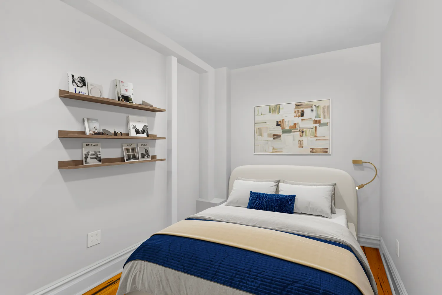 a bedroom with a bed and painting on the wall