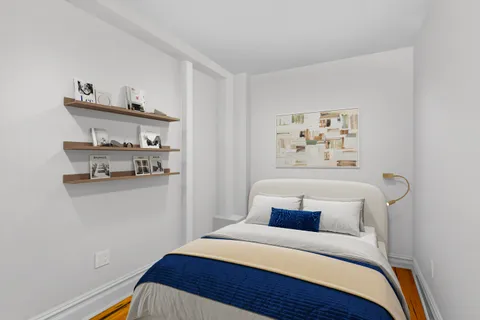 a bedroom with a bed and painting on the wall