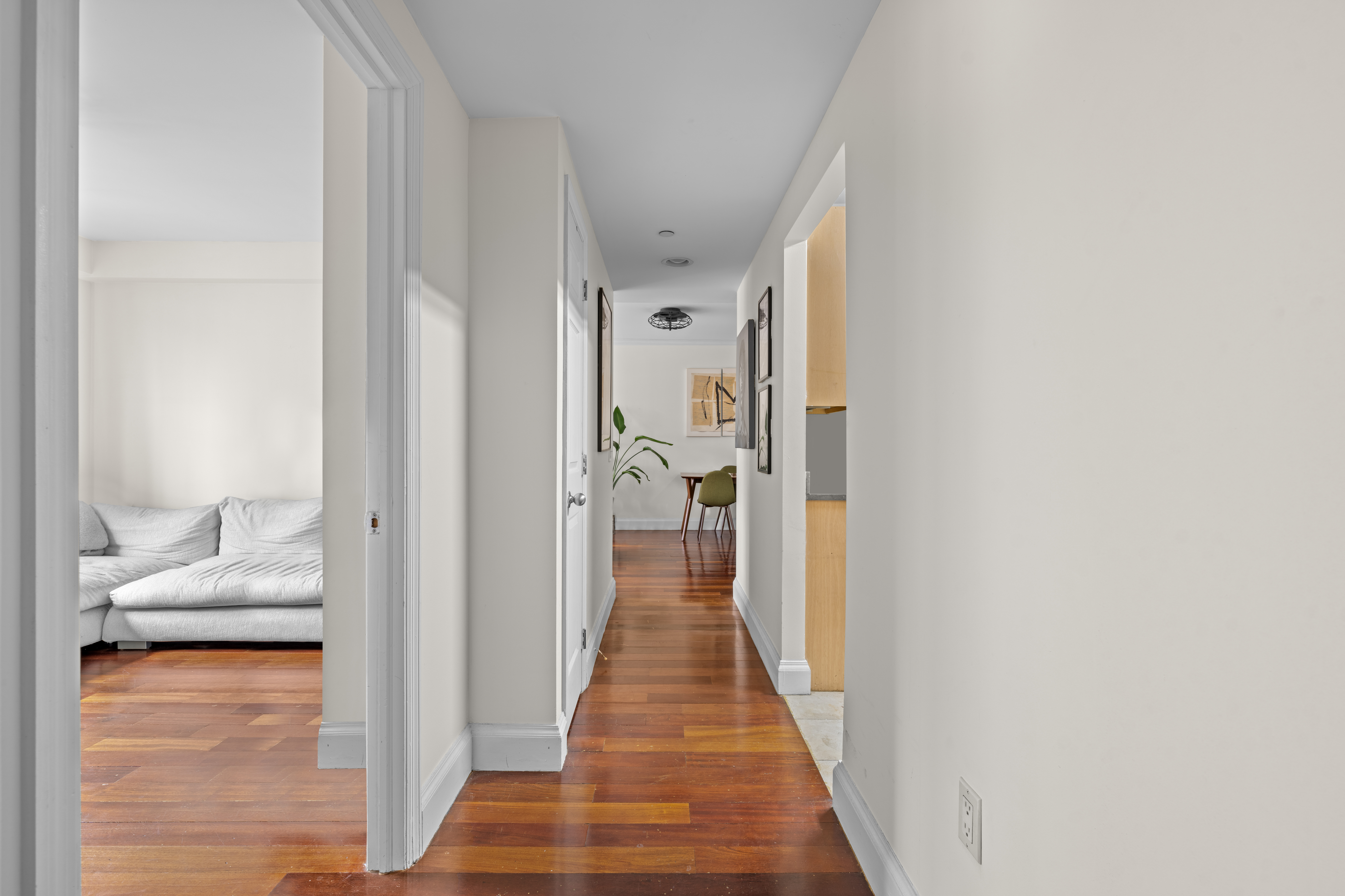163 St Nicholas Avenue, Unit 4H Manhattan, NY 10026 - Photo 11 of 16 a view of a hallway with wooden floor and a living room