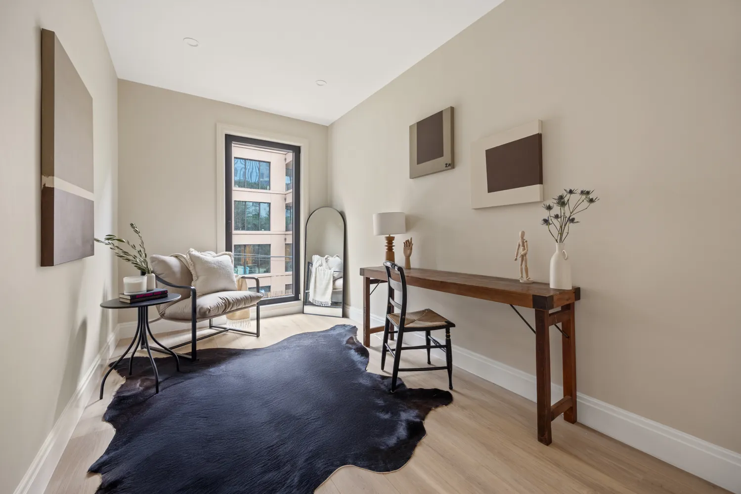 a living room with furniture a flat screen tv and a wall painting