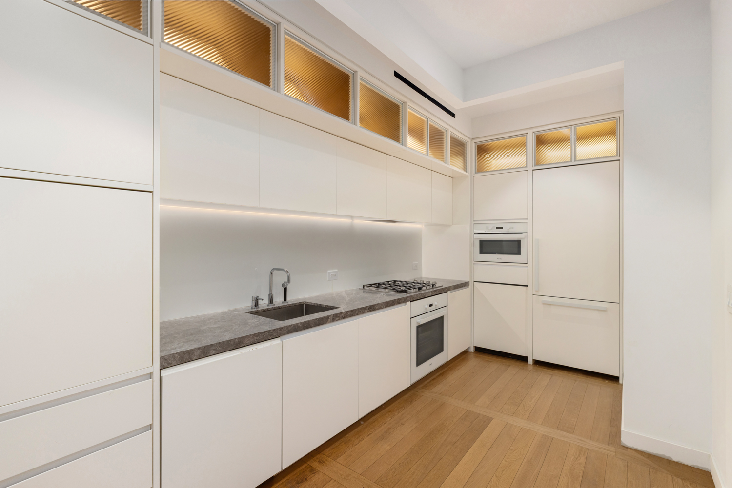 30 Warren Street, Unit 2A Manhattan, NY 10007 - Photo 3 of 10 a kitchen with a sink and cabinets