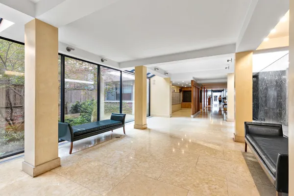 a lobby with furniture and floor to ceiling window