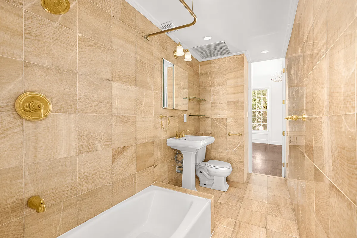 177 East 70th Street Manhattan, NY 10021 - Photo 7 of 14 a bathroom with a sink a toilet and shower