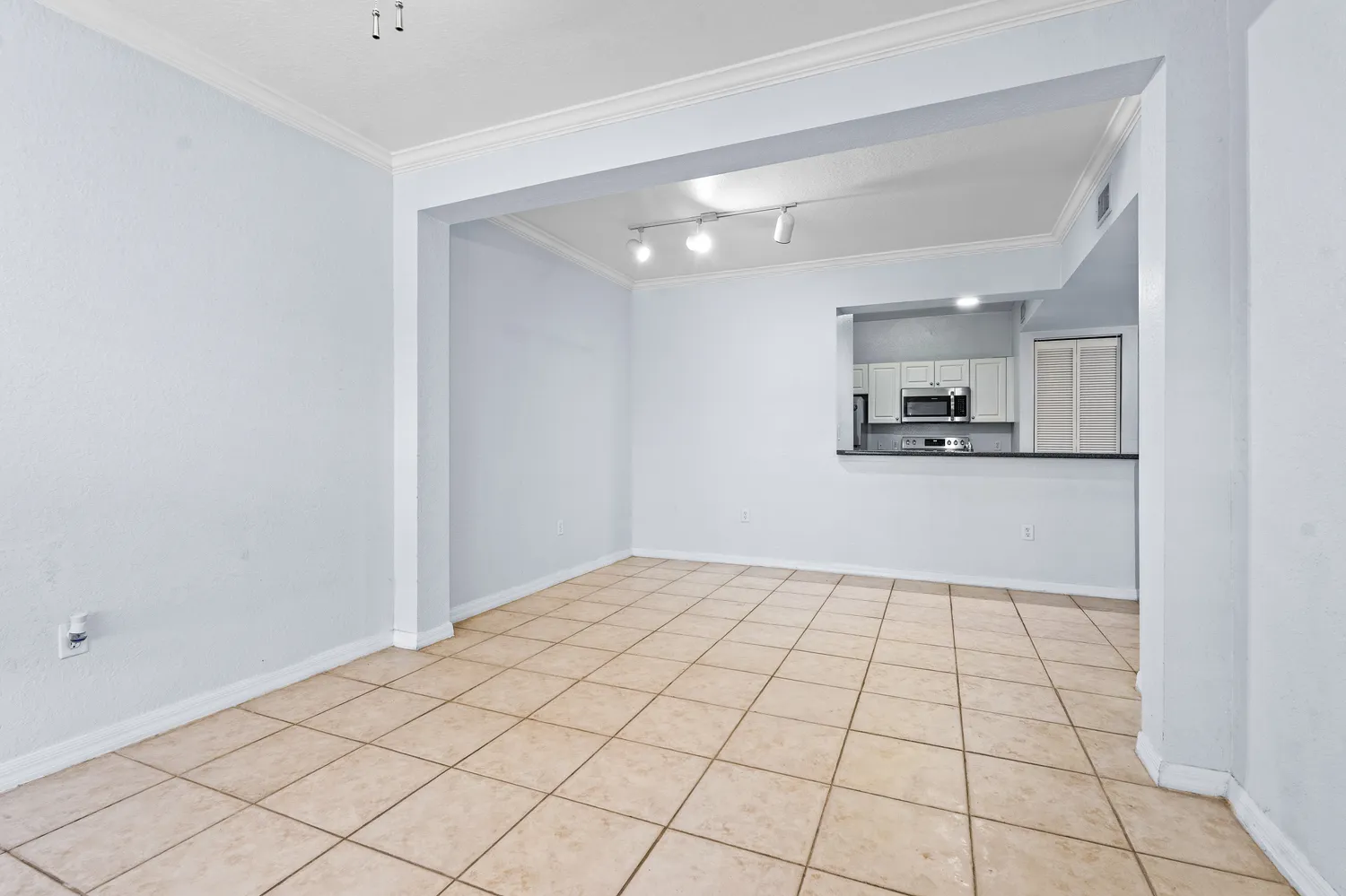a view of a kitchen with white cabinets