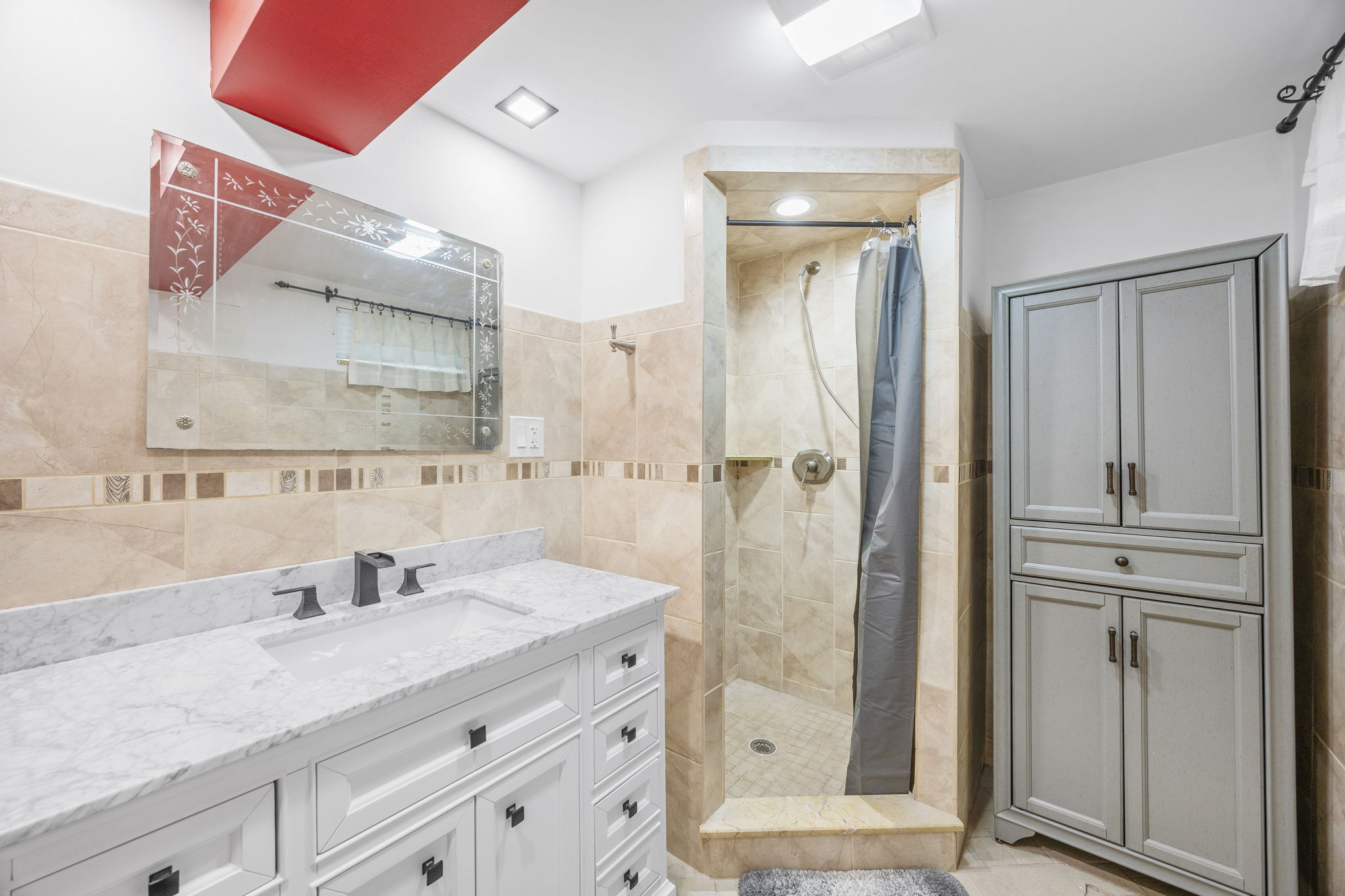 25-69 46th Street Queens, NY 11103 - Photo 29 of 33 a bathroom with a granite countertop sink vanity mirror and shower