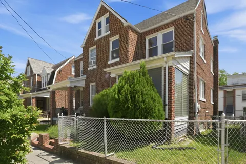 a view of a brick building next to a yard