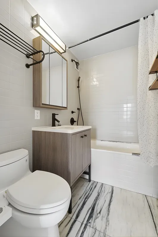 a bathroom with a sink a toilet and shower