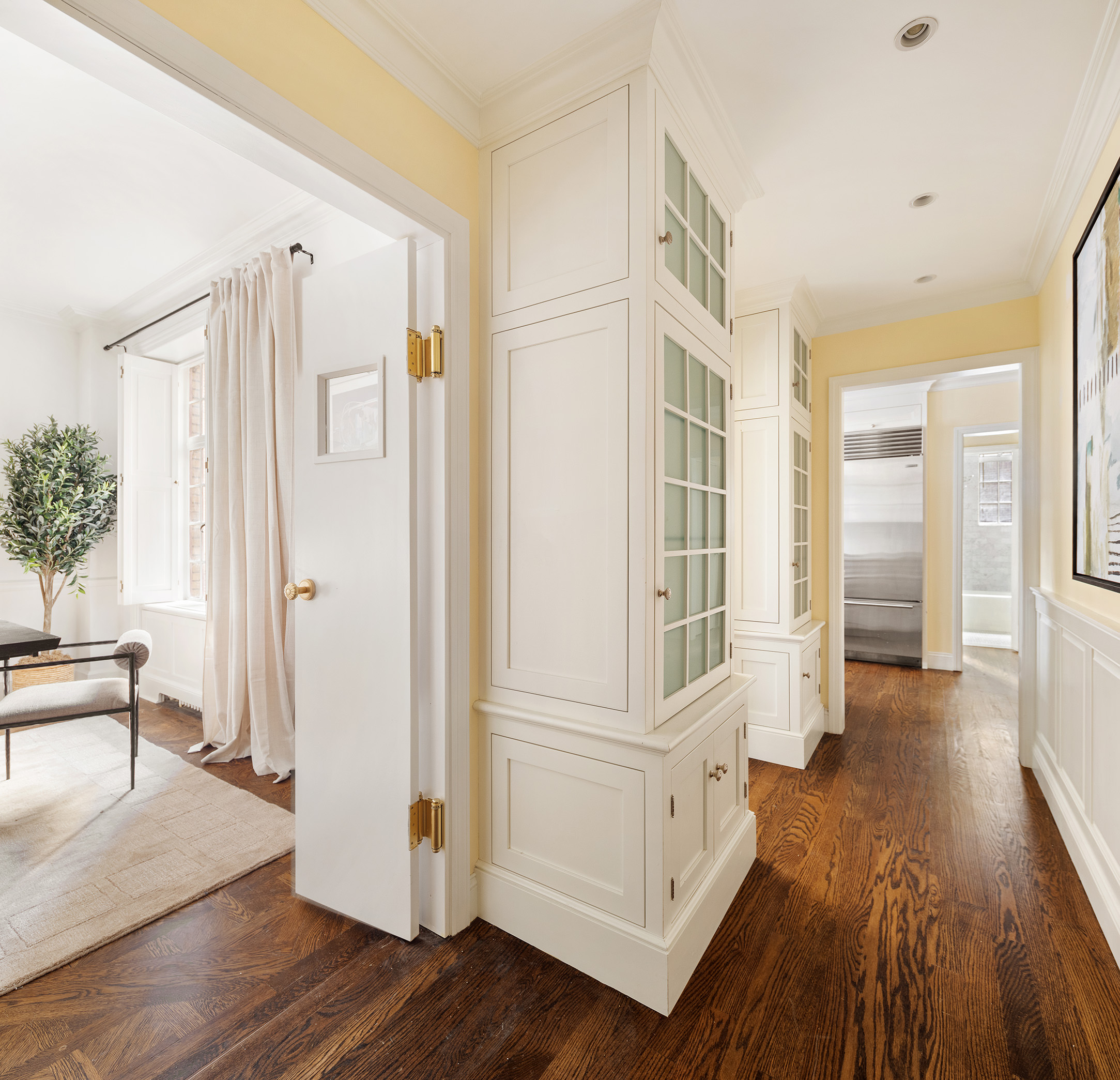 115 East 67th Street, Unit 3C Manhattan, NY 10065 - Photo 8 of 21 a view of a hallway with wooden floor and staircase