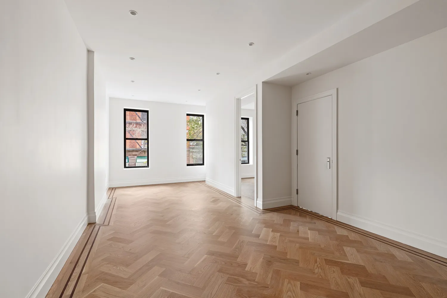 an empty room with windows and closet