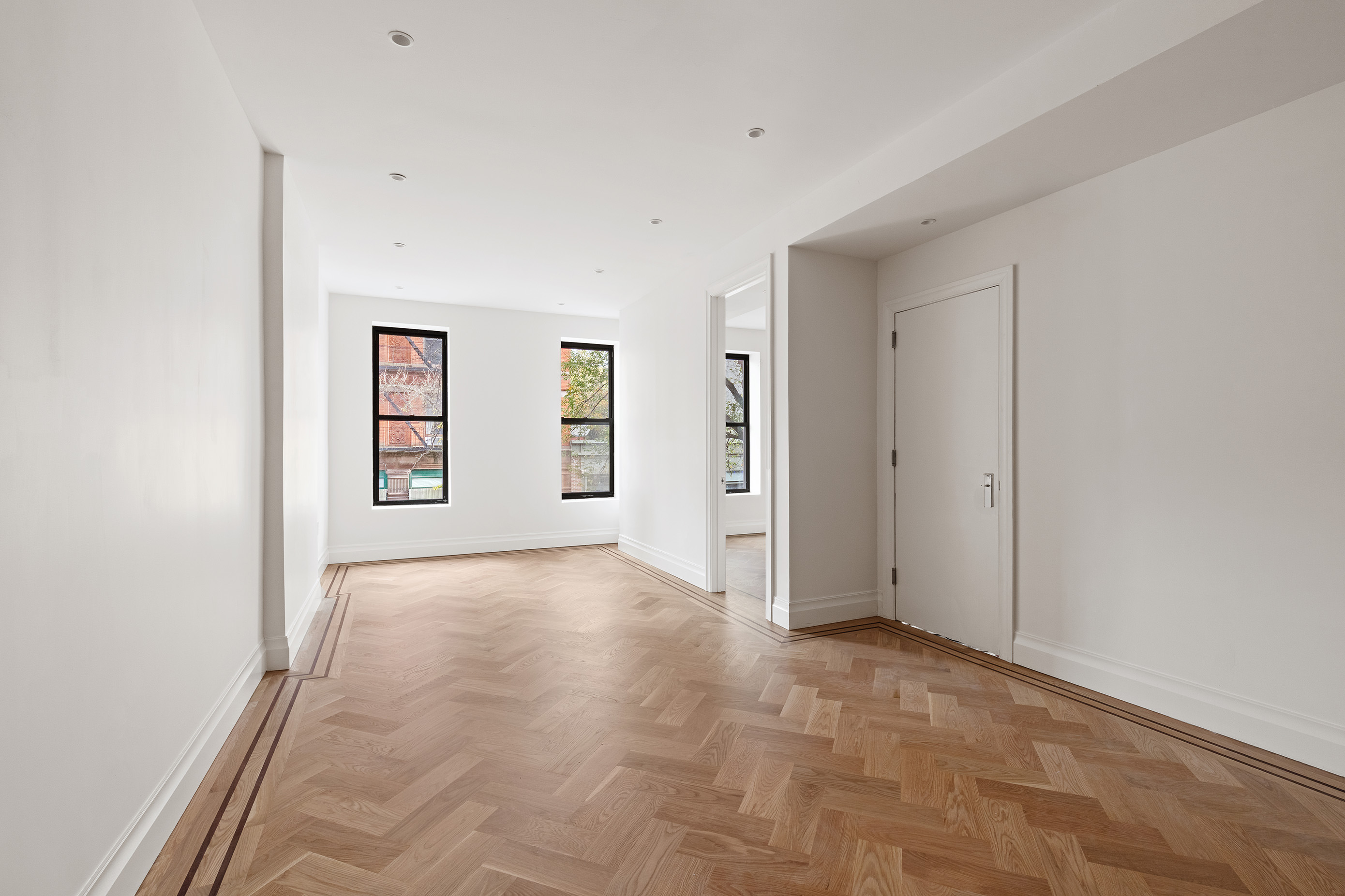 an empty room with windows and closet