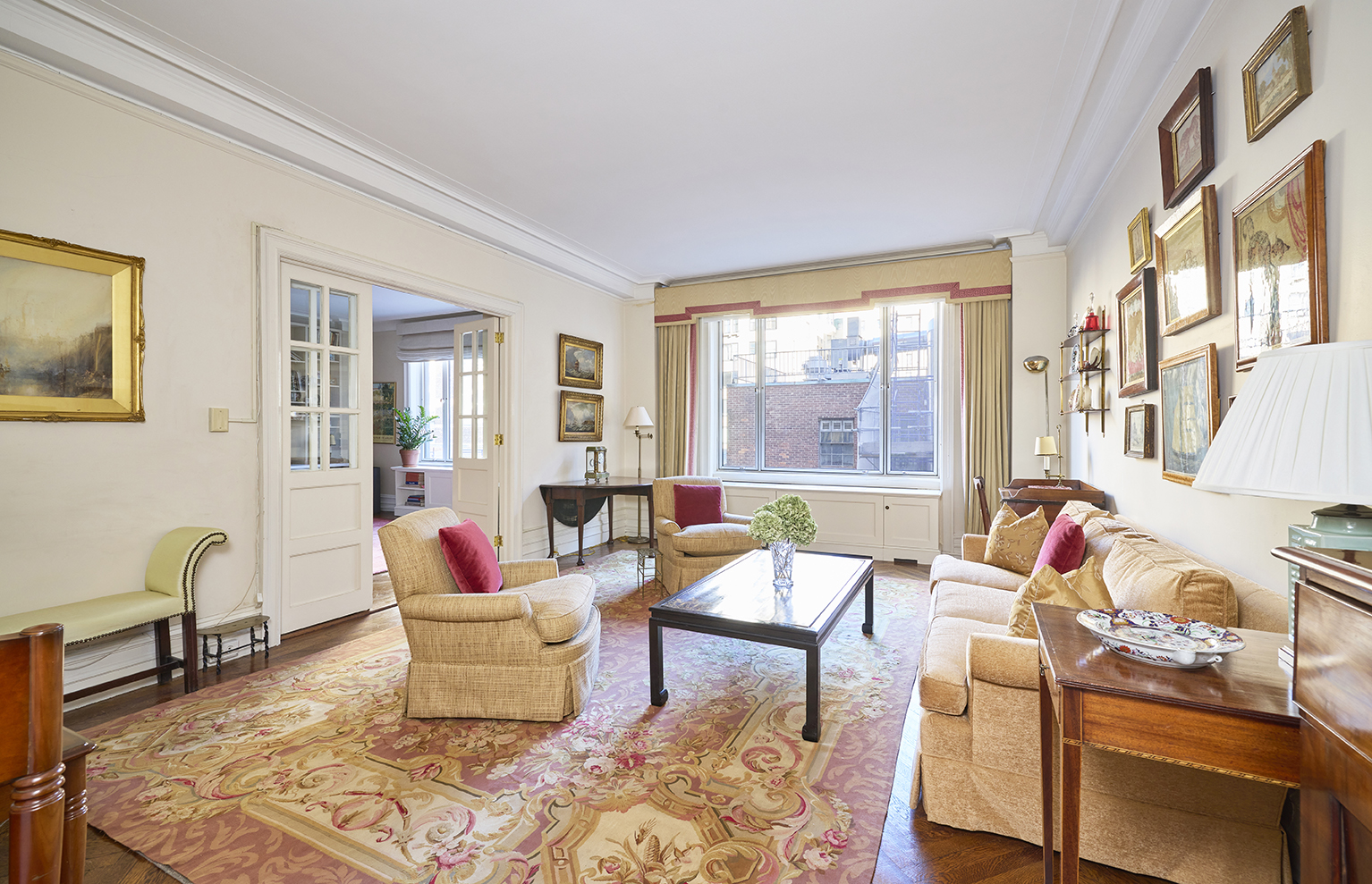 161 East 79th Street, Unit 7B Manhattan, NY 10075 - Photo 1 of 15 a living room with furniture and floor to ceiling windows