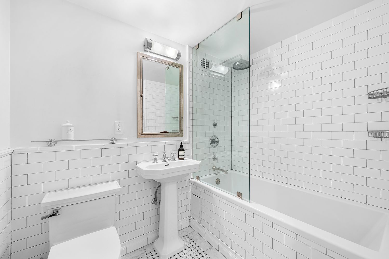 410 West 24th Street, Unit 6J Manhattan, NY 10011 - Photo 5 of 8 a bathroom with a sink a toilet and shower