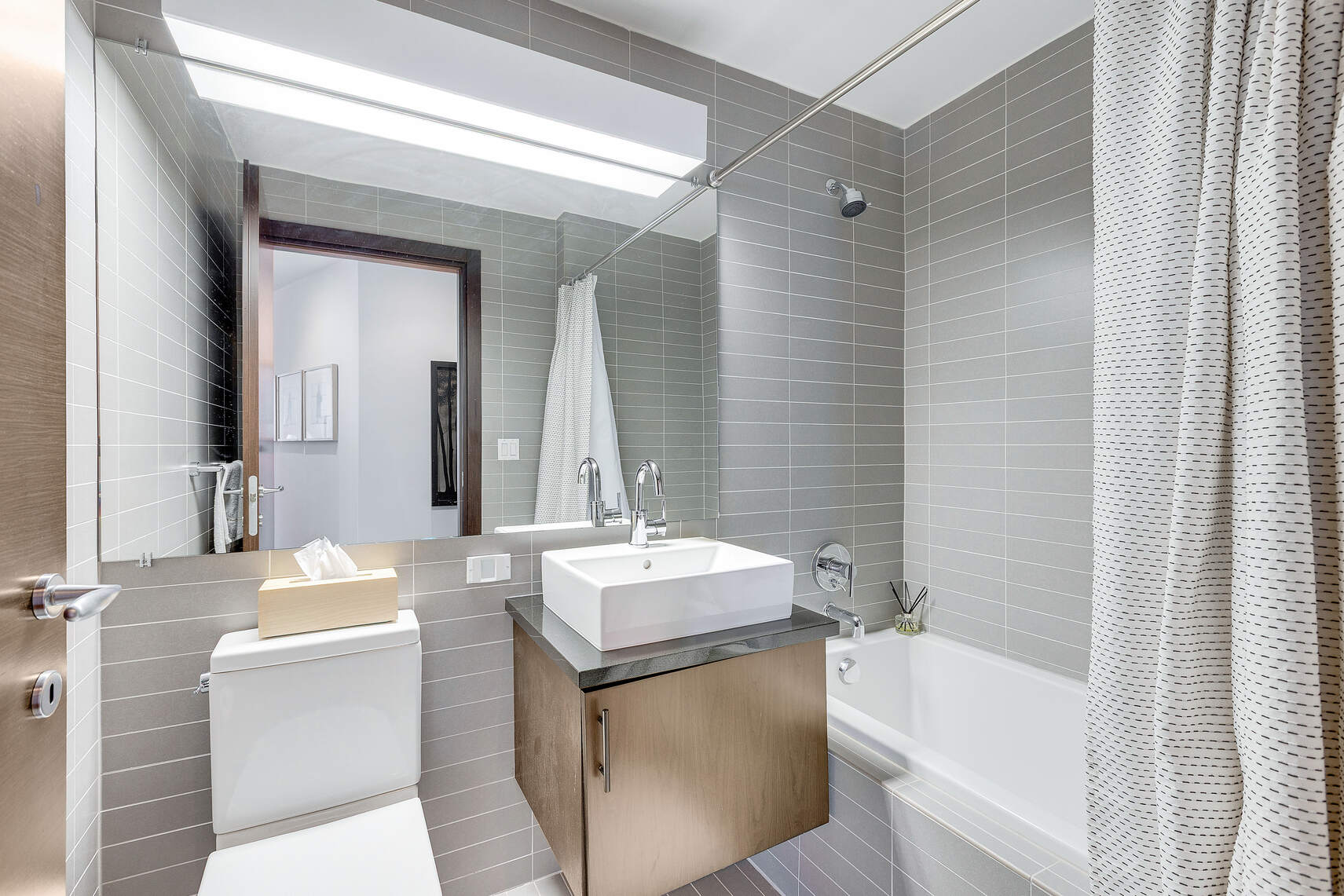 150 Myrtle Avenue, Unit 2503 Brooklyn, NY 11201 - Photo 11 of 28 a bathroom with a sink tub vanity and a mirror