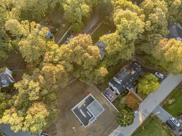 an aerial view of house with yard and parking