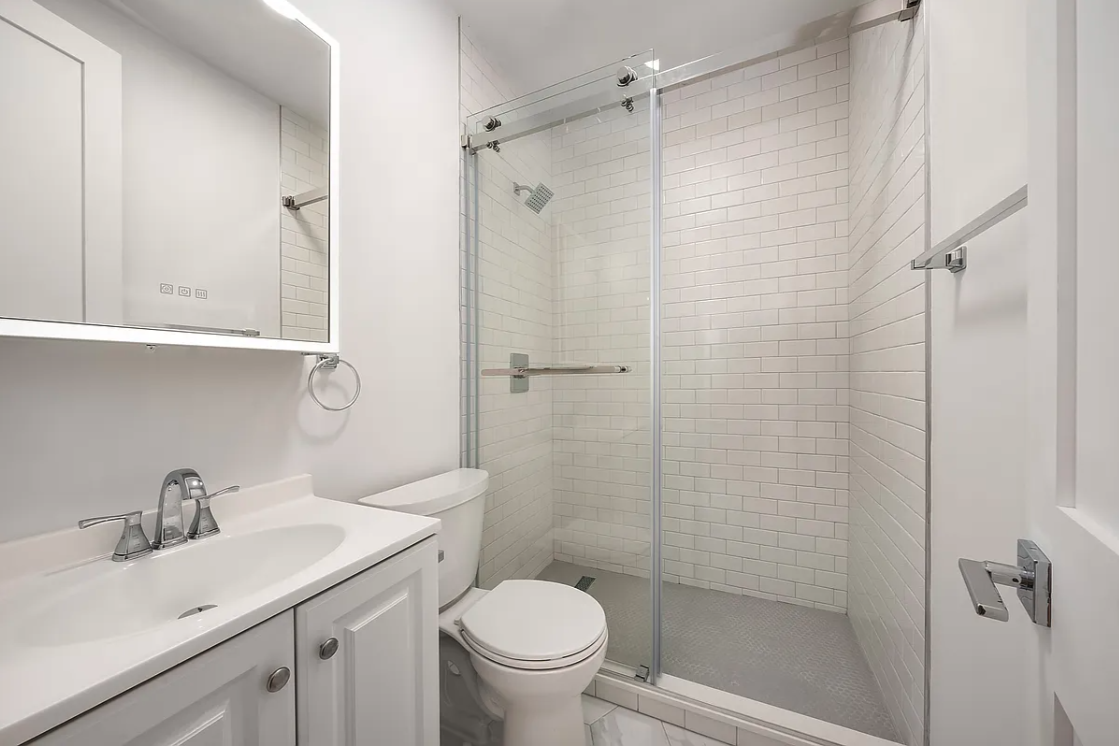 130 West 80th Street, Unit 5R Manhattan, NY 10024 - Photo 6 of 7 a bathroom with a sink toilet and shower