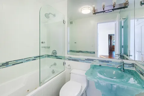 a bathroom with a sink a toilet and bathtub