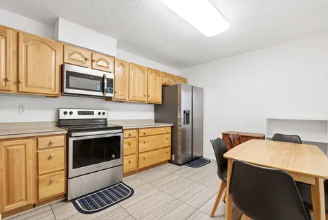 a kitchen with stainless steel appliances granite countertop a sink and cabinets