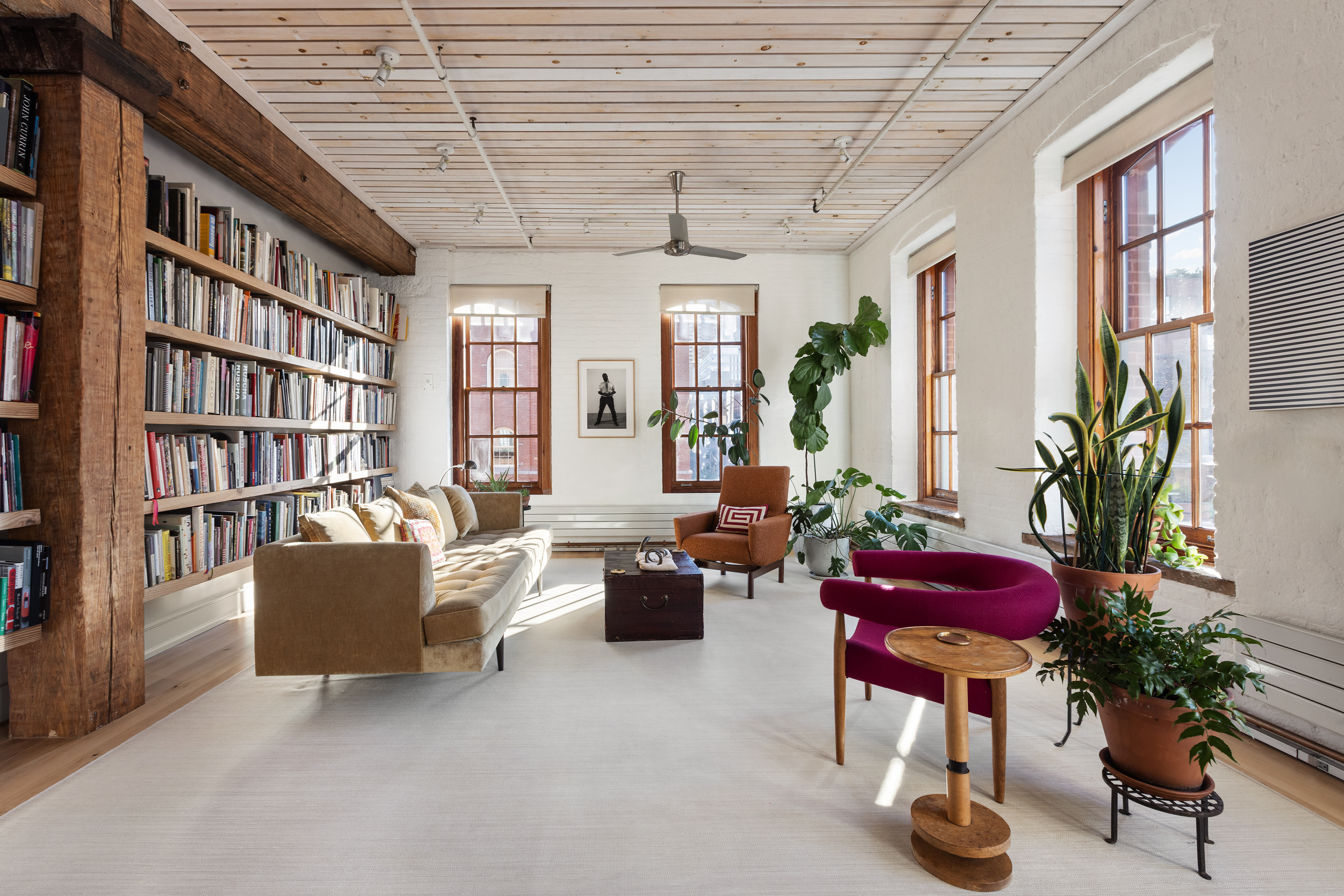 463 Greenwich Street Manhattan, NY 10013 - Photo 8 of 24 a living room with furniture and a book shelf