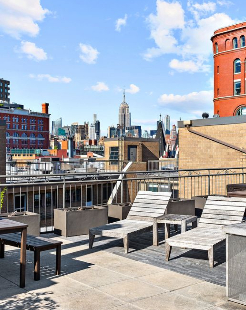 130 Barrow Street, Unit 302 Manhattan, NY 10014 - Photo 9 of 11 a view of a balcony with wooden benches