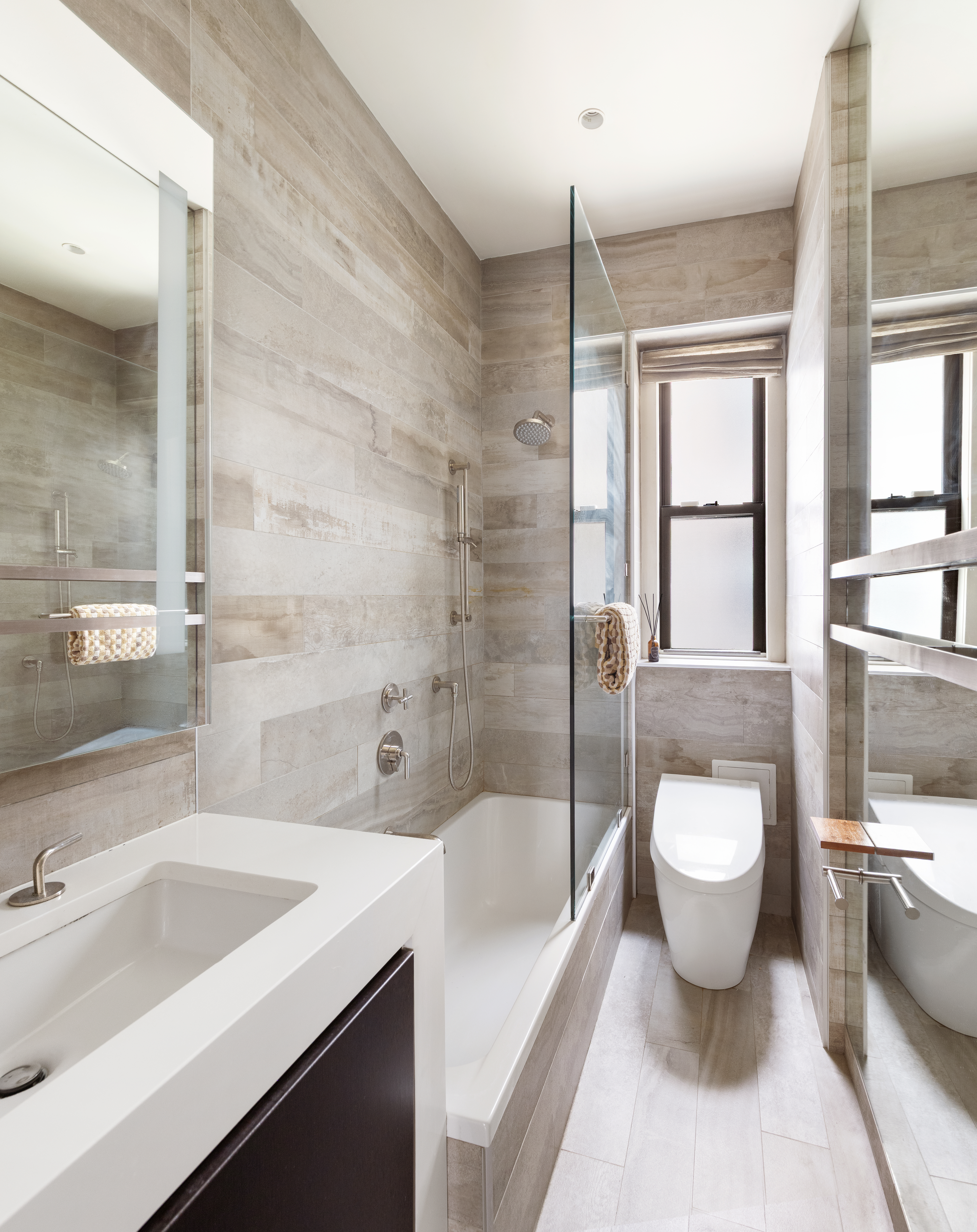 130 West 16th Street, Unit 6 Manhattan, NY 10011 - Photo 6 of 9 a bathroom with a granite countertop sink toilet and shower