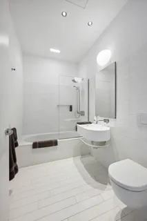a bathroom with a sink a toilet and a large mirror