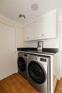 a utility room with sink dryer and washer