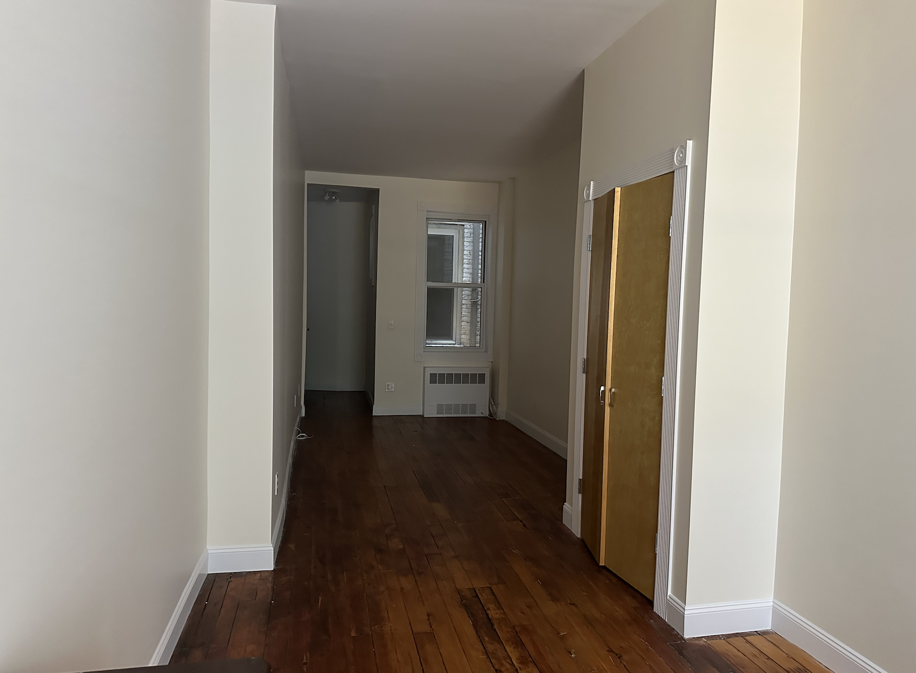 459 West 35th Street, Unit 1E Manhattan, NY 10001 - Photo 3 of 18 a view of a hallway with wooden floor