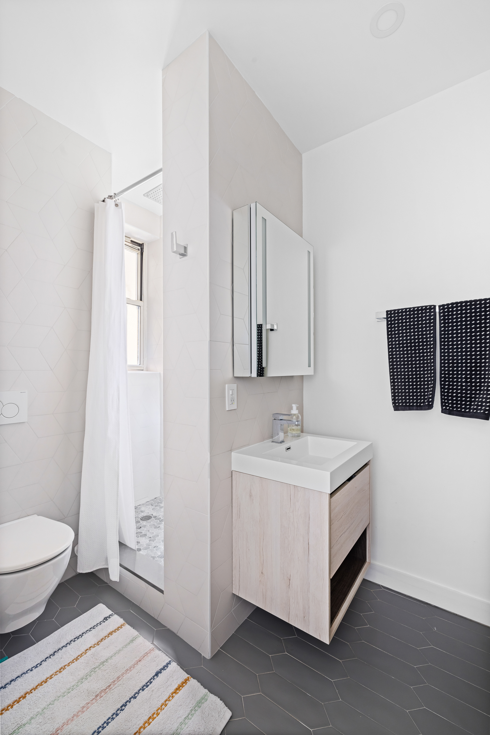 240 West 98th Street, Unit 8D Manhattan, NY 10025 - Photo 9 of 12 a spacious bathroom with a double vanity sink toilet and a mirror