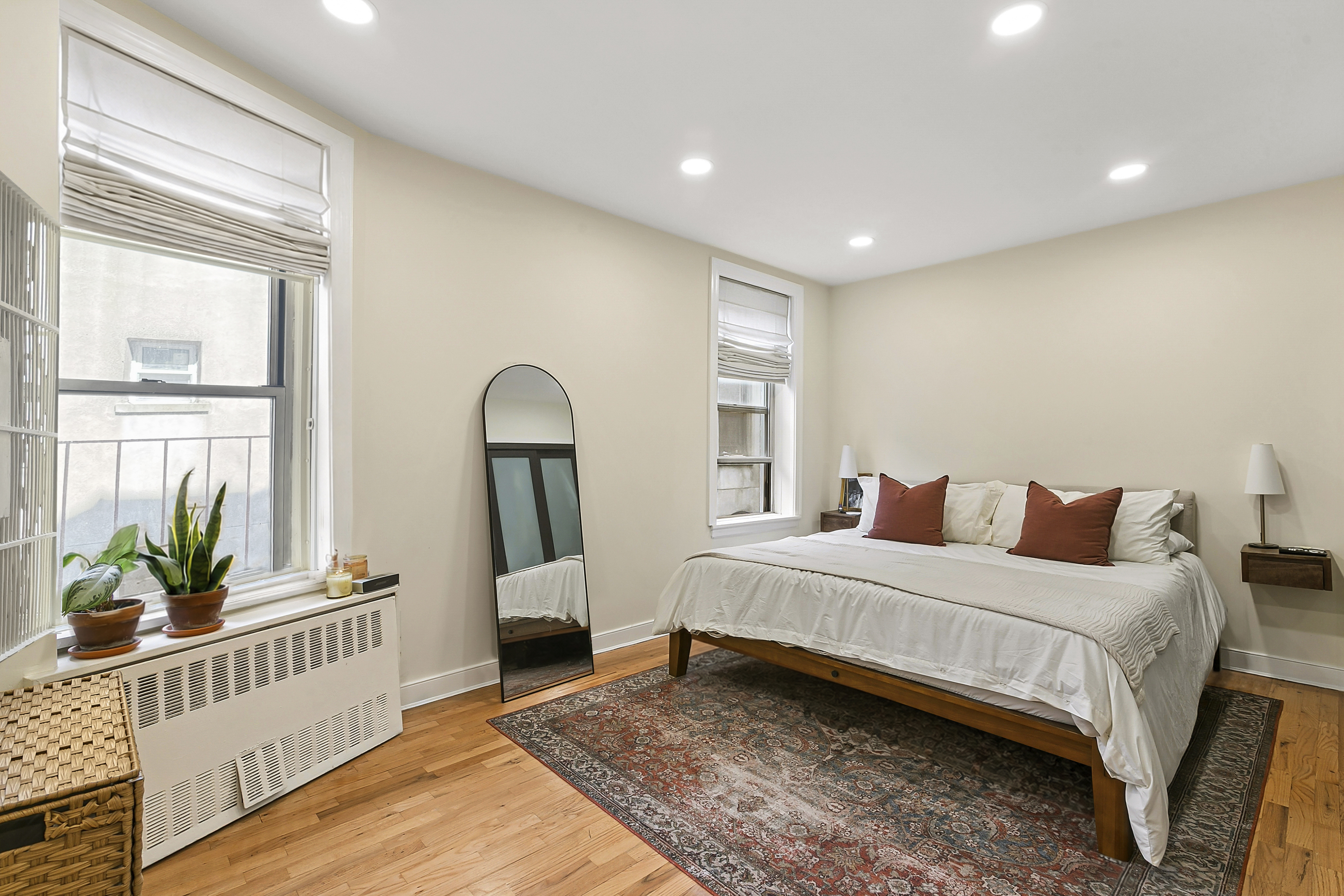 446 Central Park West, Unit 6D Manhattan, NY 10025 - Photo 3 of 9 a bedroom with a bed a mirror and furniture