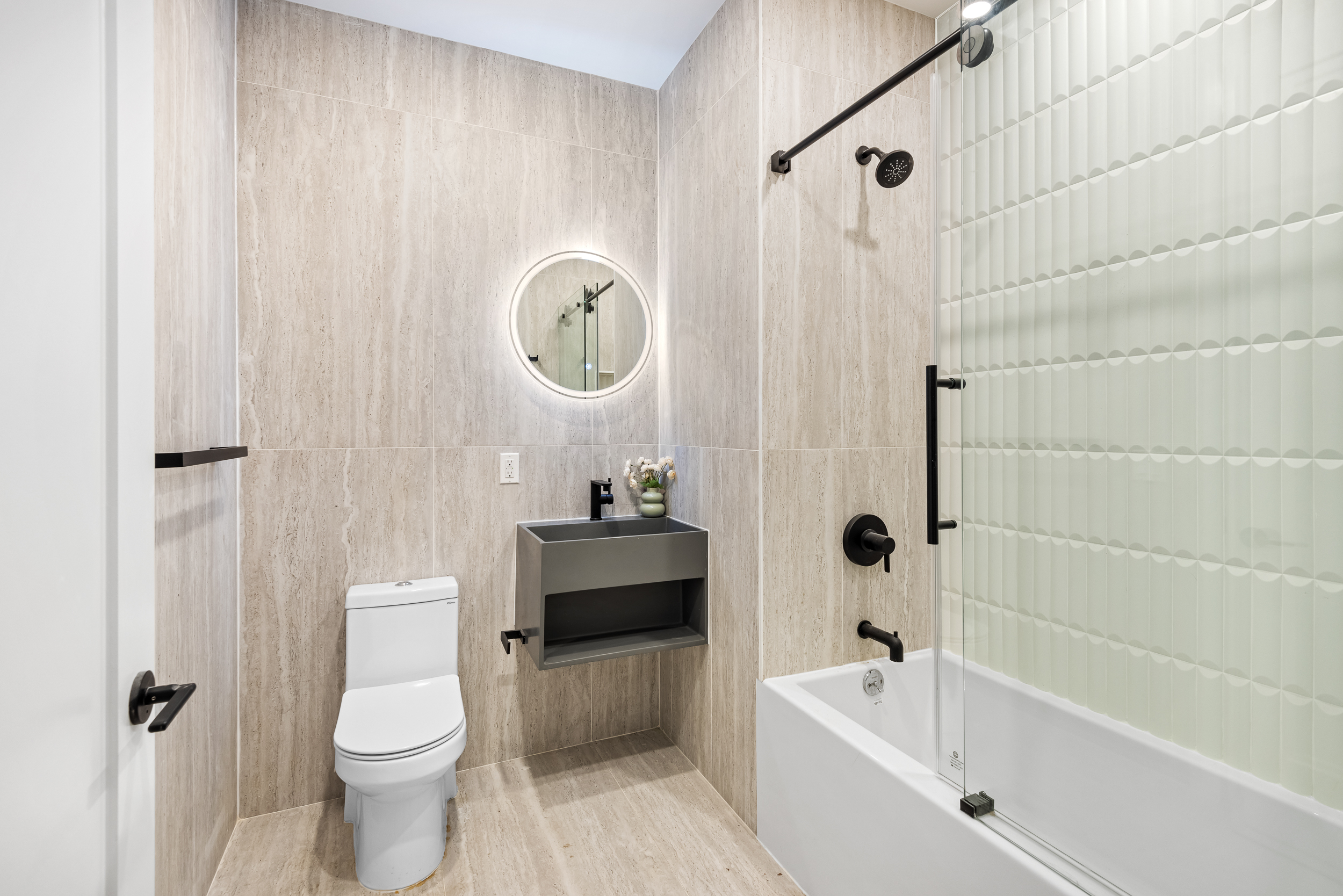 140 Moffat Street, Unit 1 Brooklyn, NY 11207 - Photo 7 of 9 a bathroom with a toilet a sink and bathtub