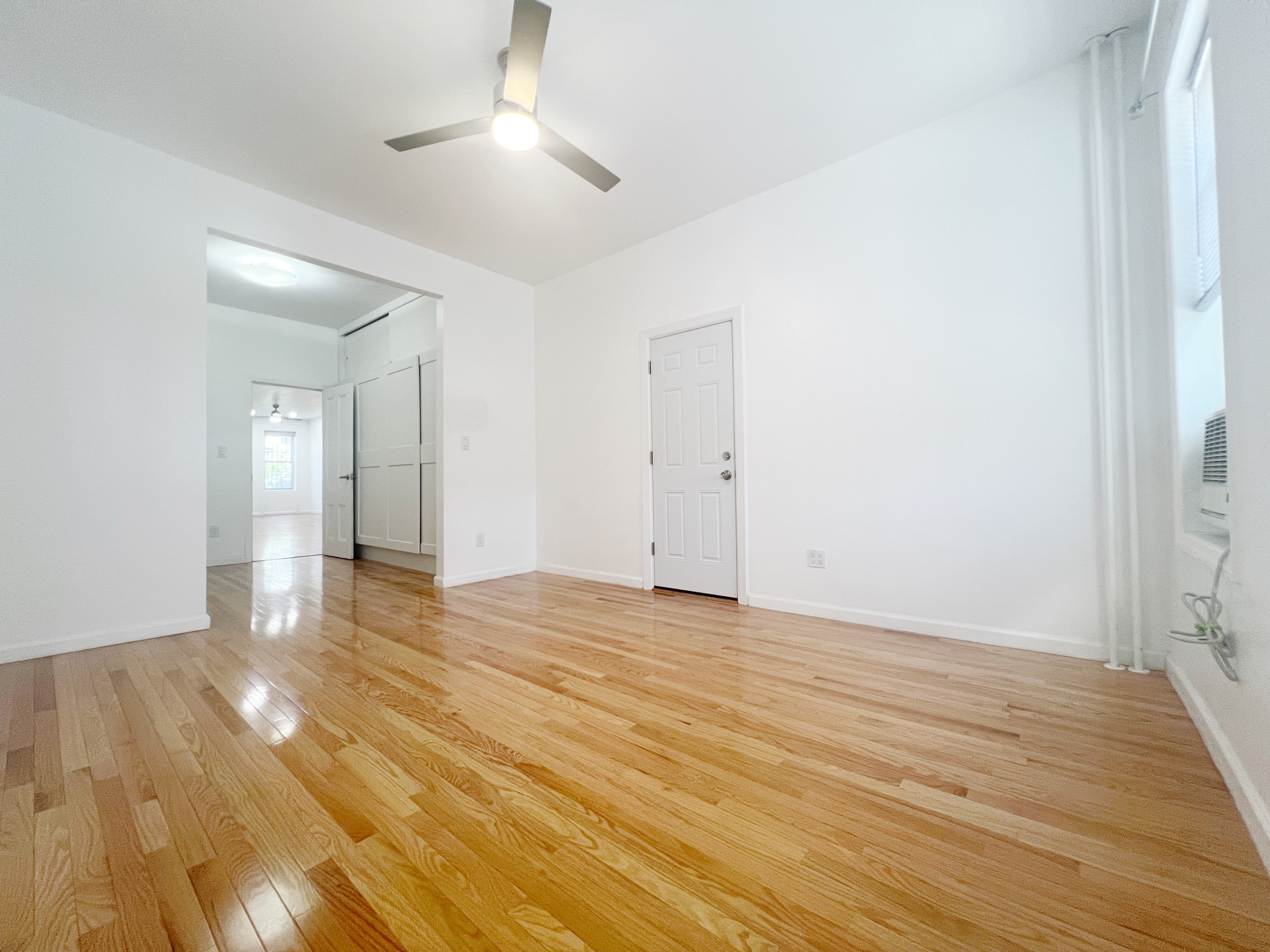 17-22 Menahan Street, Unit 1 Queens, NY 11385 - Photo 4 of 9 a view of an empty room and wooden floor