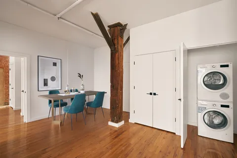 a view of a hallway with dining area closet and wooden floor