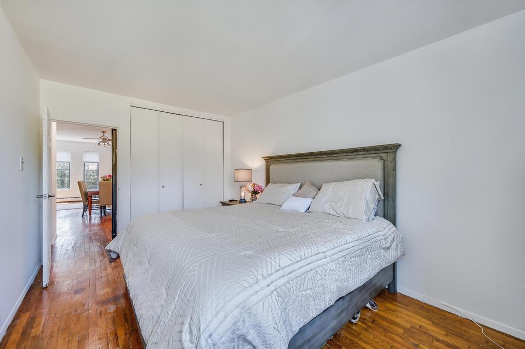 57 Carroll Street, Unit 38A Brooklyn, NY 11231 - Photo 19 of 21 a bedroom with a bed and wooden floor