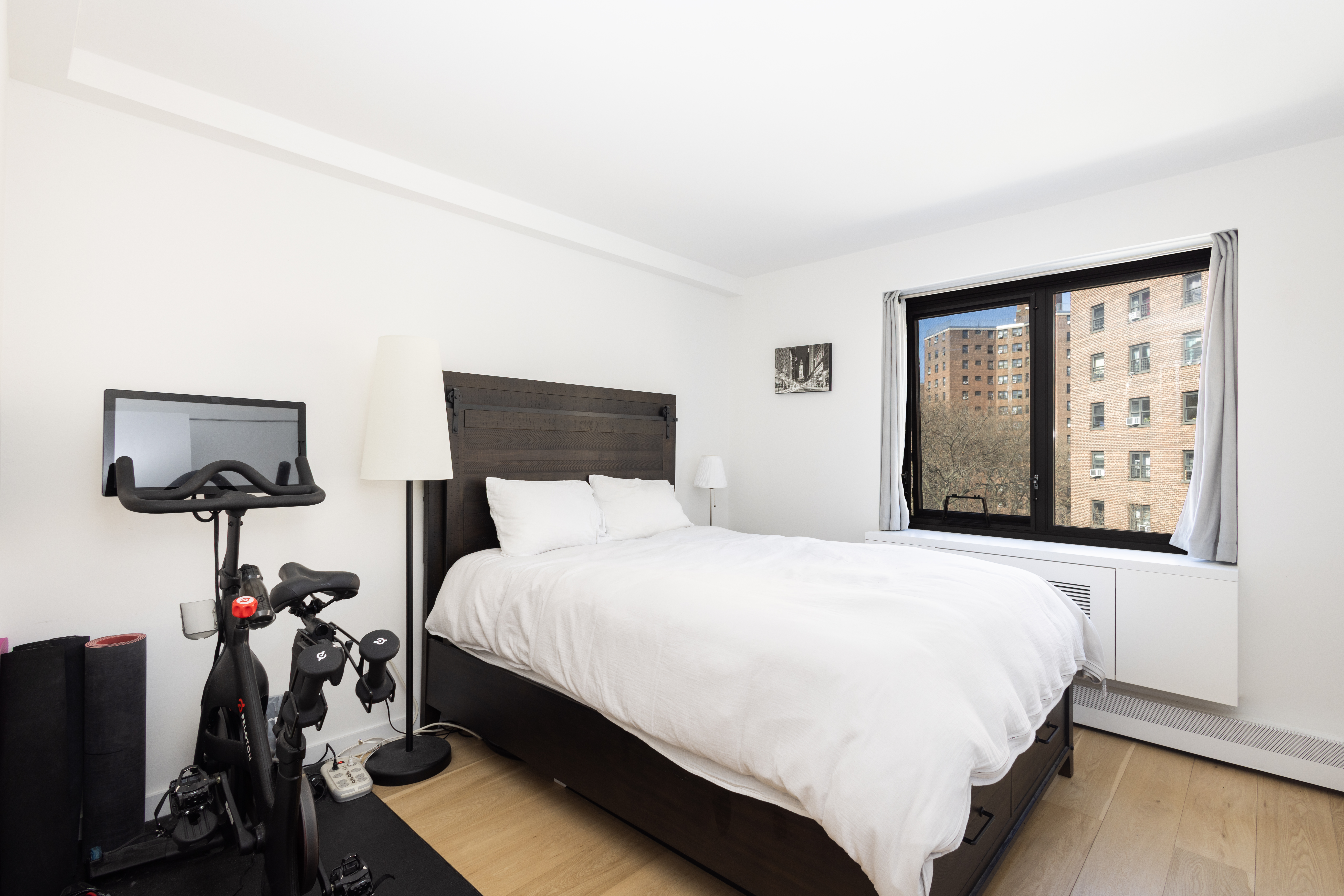 1330 5th Avenue, Unit 6C Manhattan, NY 10026 - Photo 9 of 16 a bedroom with a bed tv and a window