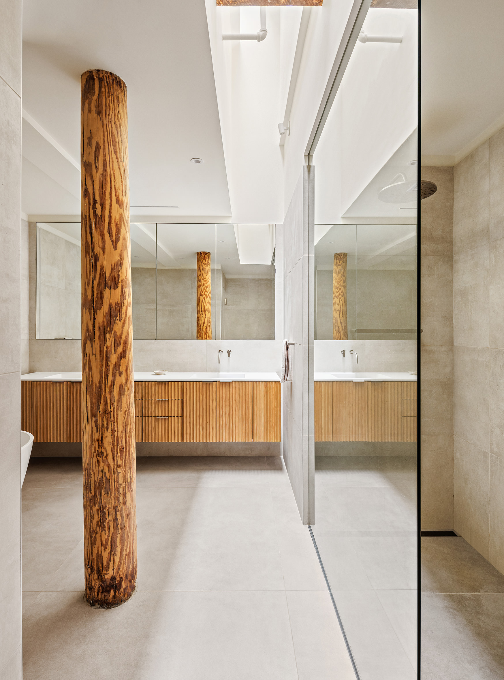 477 Broome Street Manhattan, NY 10013 - Photo 9 of 18 a bathroom with a tub sink and mirror