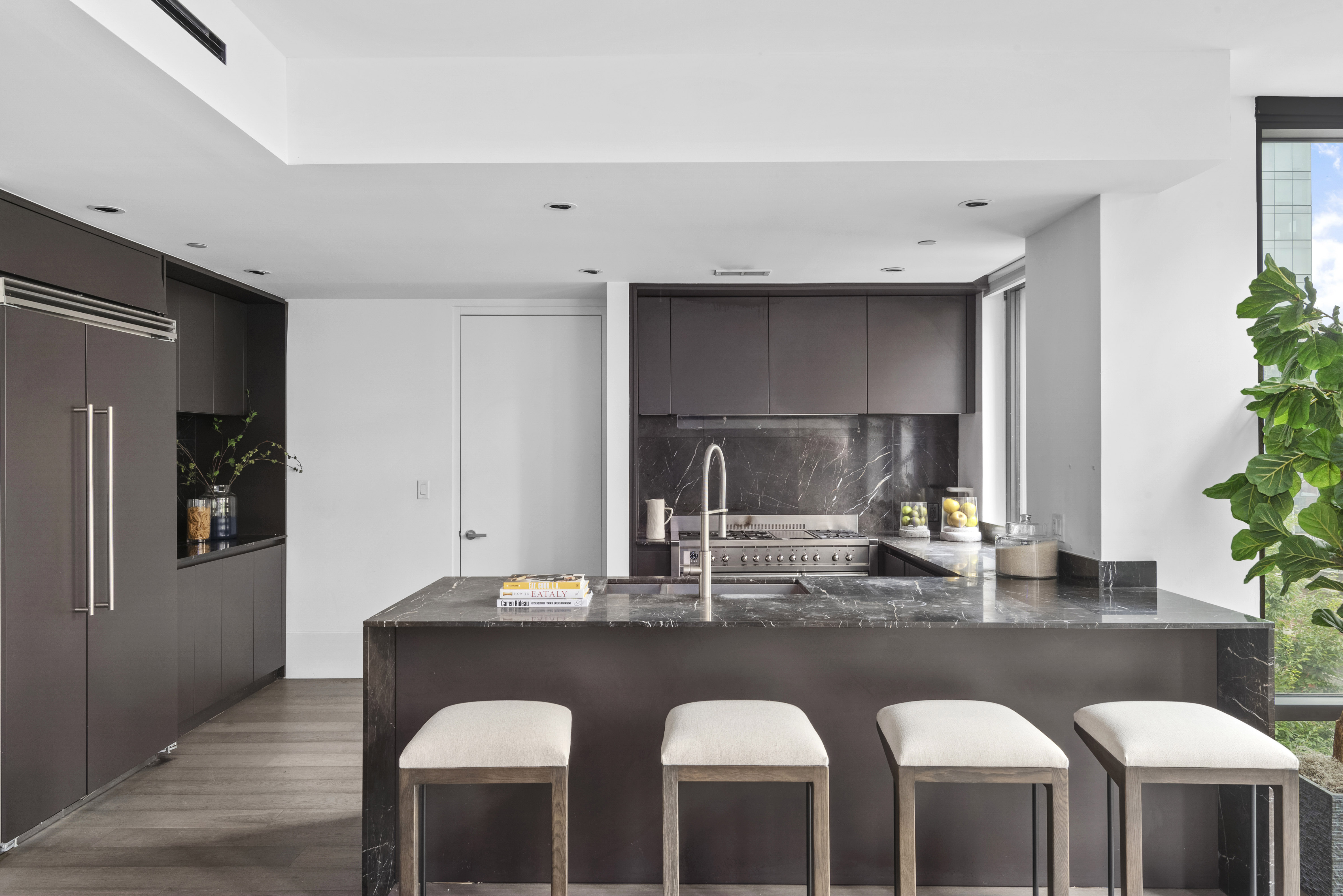 429 Kent Avenue, Unit L32 Brooklyn, NY 11249 - Photo 5 of 15 a kitchen with a sink and chairs