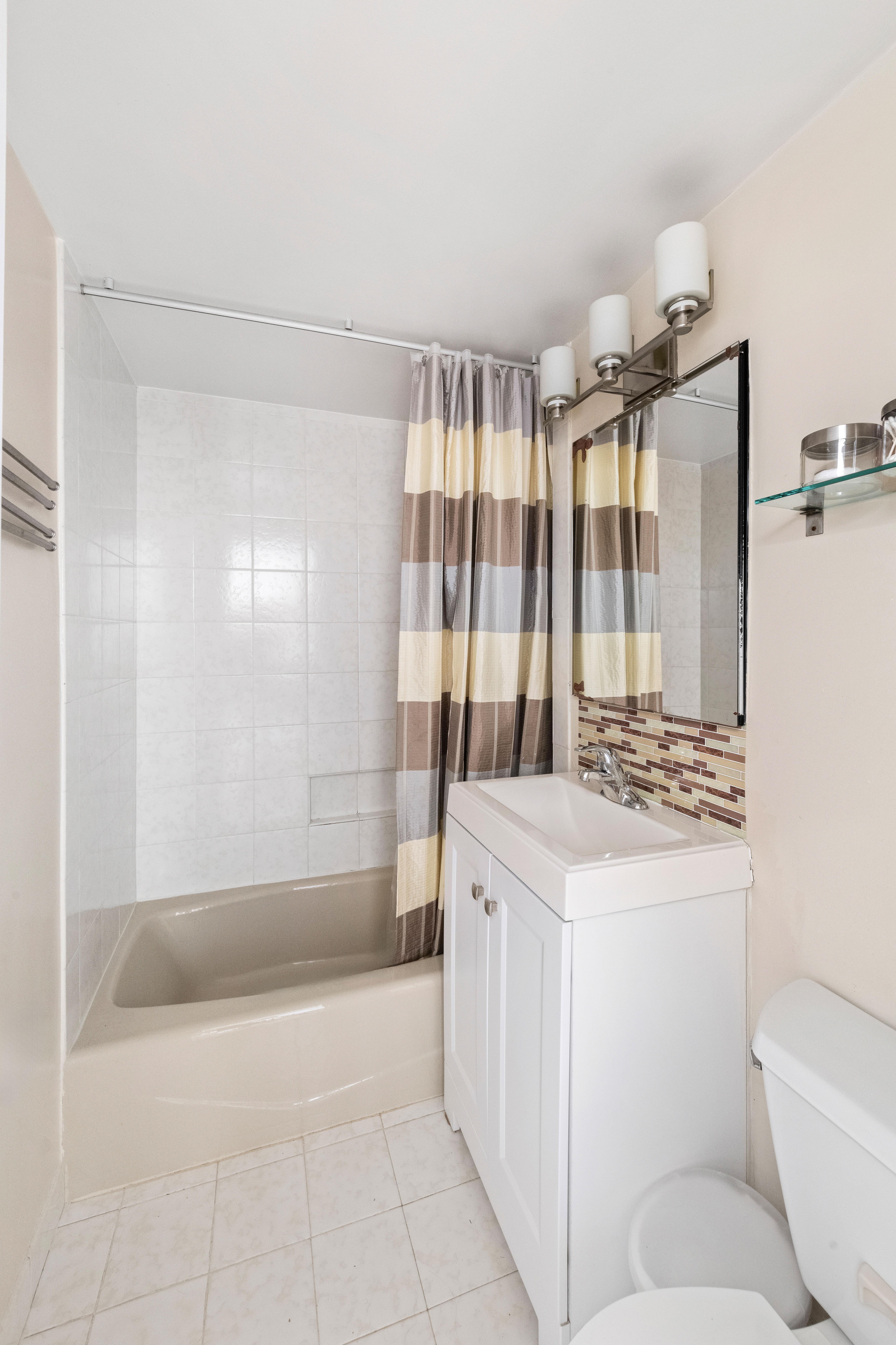315 East 69th Street, Unit 4K Manhattan, NY 10021 - Photo 5 of 8 a bathroom with a sink toilet and shower