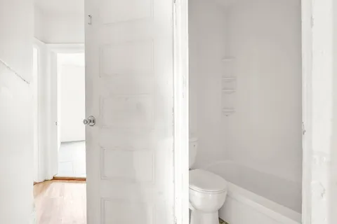a bathroom with a toilet and a shower
