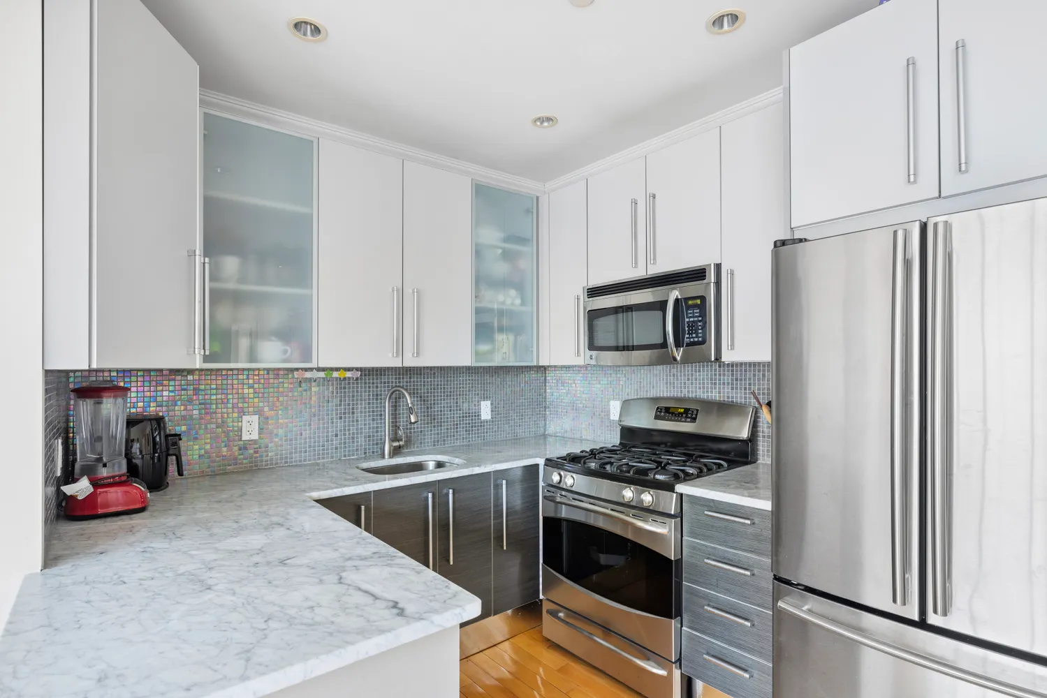 a kitchen with stainless steel appliances granite countertop a sink stove and refrigerator