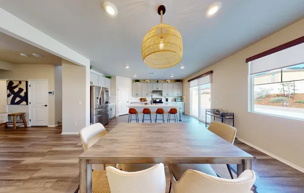 a kitchen with a refrigerator a stove top oven a sink dishwasher and white cabinets with wooden floor