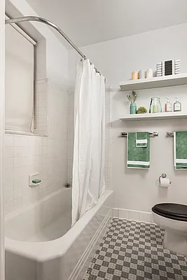 26 East 63rd Street, Unit 5F Manhattan, NY 10065 - Photo 3 of 5 a bathroom with a bathtub and a shower