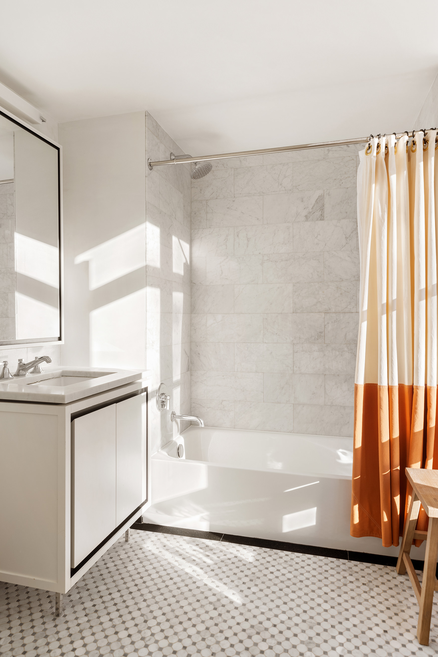 261 Hudson Street, Unit 5S Manhattan, NY 10013 - Photo 5 of 6 a bathroom with a granite countertop sink a mirror and a bathtub