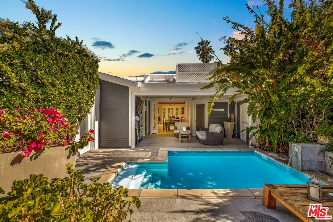 a front view of a house with outdoor seating