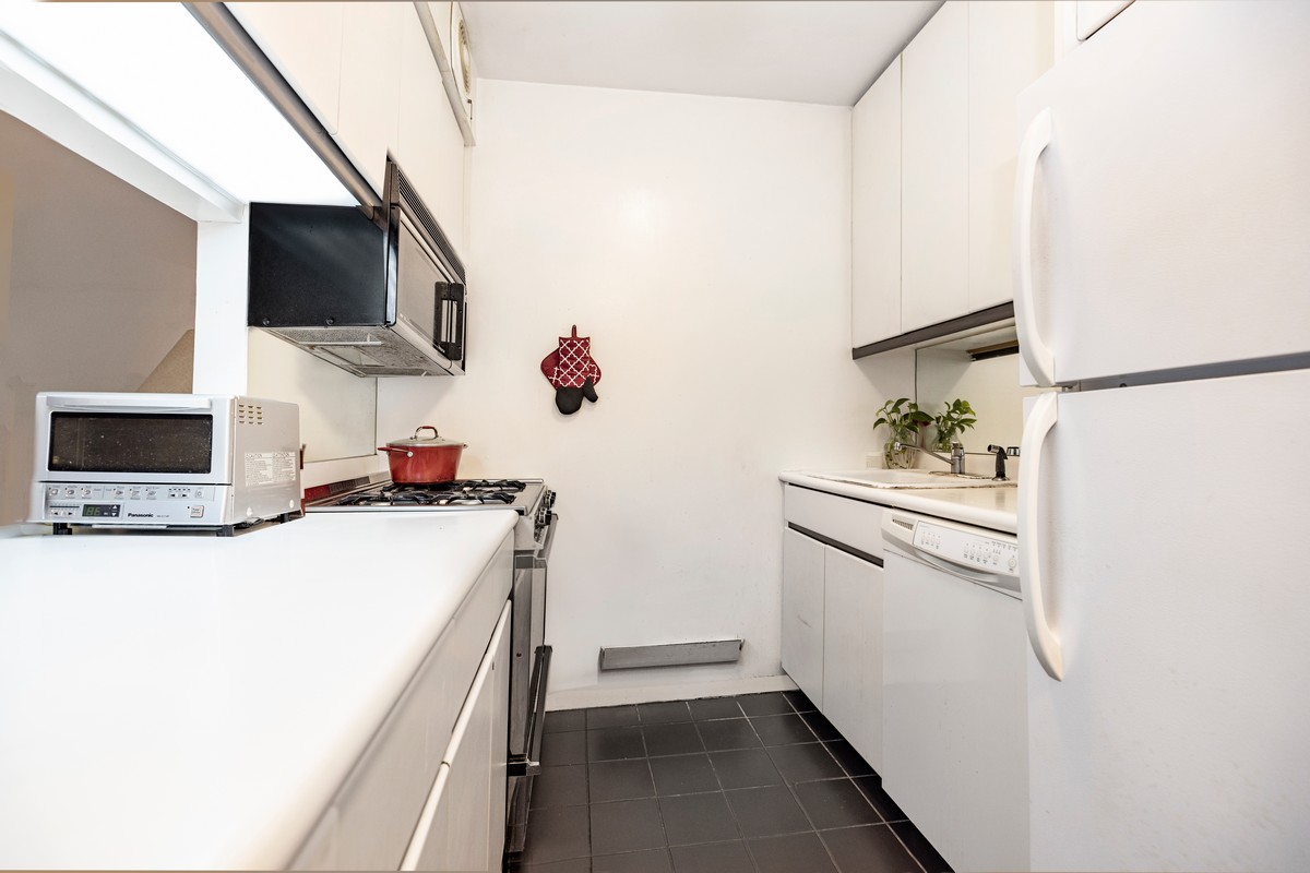 250 West 89th Street, Unit 5A Manhattan, NY 10024 - Photo 3 of 8 a kitchen with a refrigerator and a stove