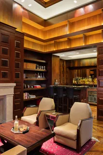 a room with lots of chairs and mirrors