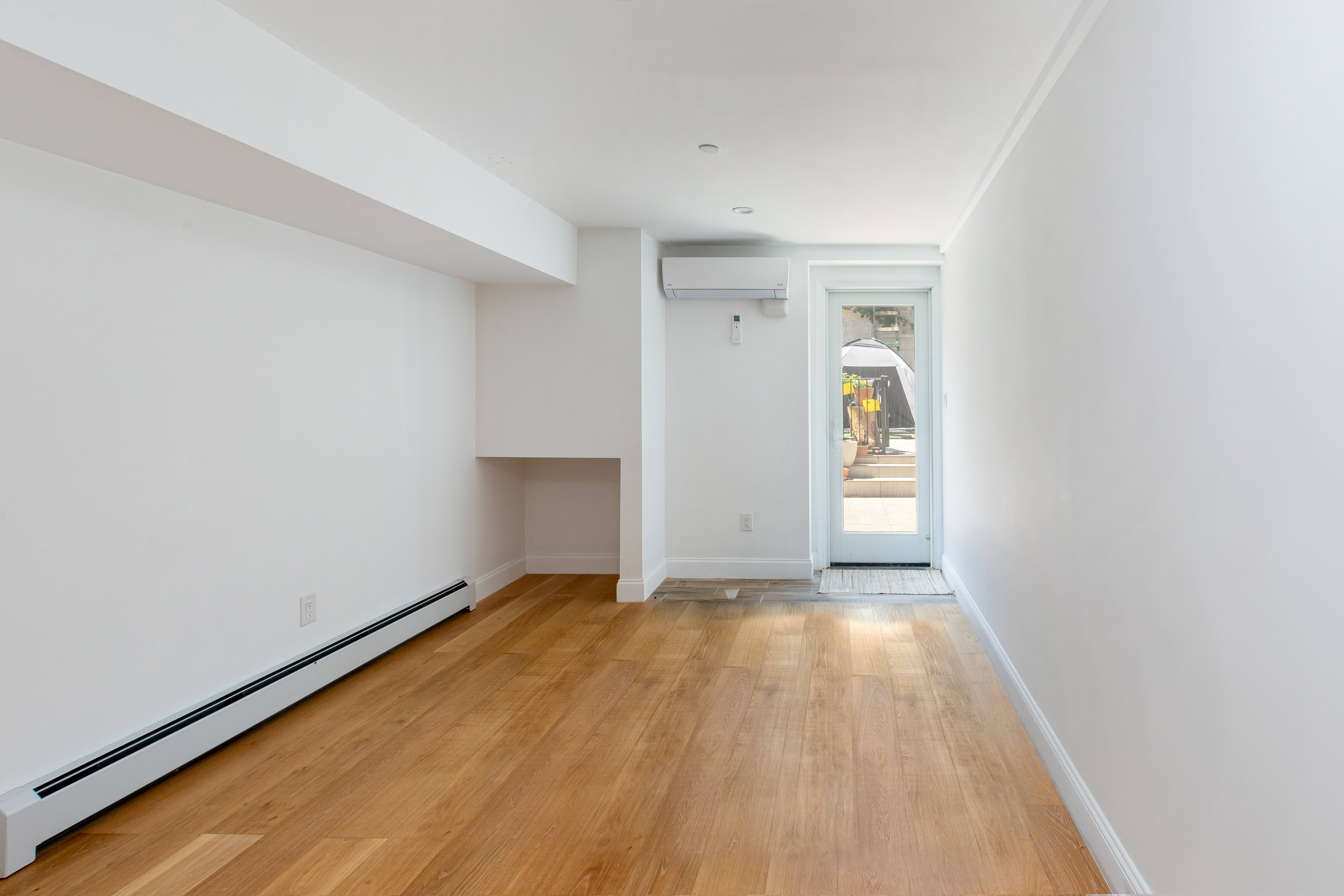 492 Warren Street, Unit GARDEN Brooklyn, NY 11217 - Photo 3 of 8 a view of an empty room with wooden floor