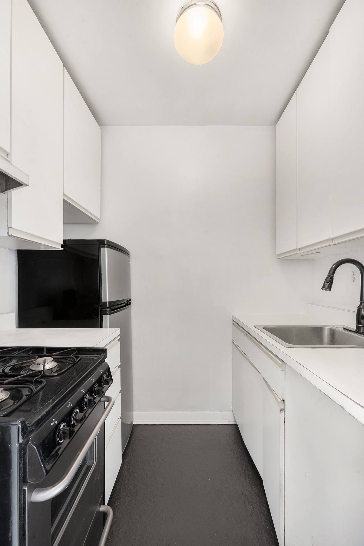 61 Jane Street, Unit 15K Manhattan, NY 10014 - Photo 12 of 16 a kitchen with a stove and a sink